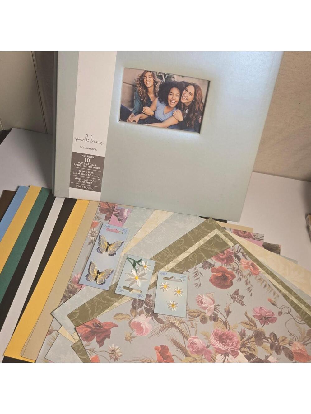Curated scrapbooking kit with teal scapbook paper appliques and more